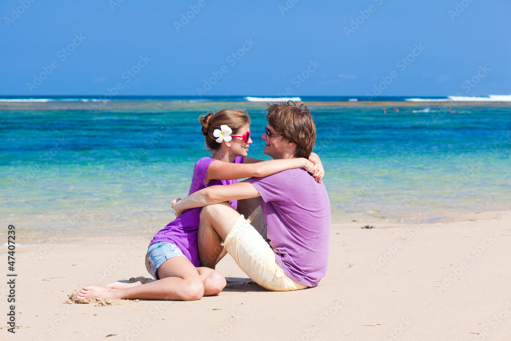 young beautiful couple on tropical bali beach.honeymoon young beautiful couple on tropical bali beach.honeymoon