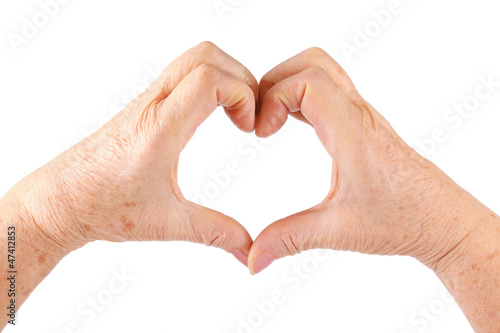 woman senior hands show heart gesture, isolated