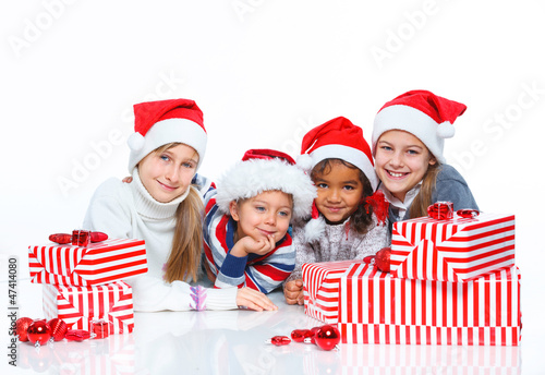 Happy kids in Santa's hat with gift box