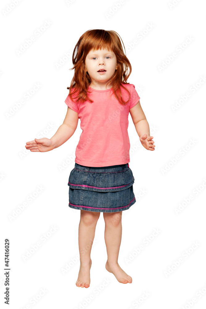 Happy little redhead girl dancing and smiling. Happy little redhead girl dancing and smiling.