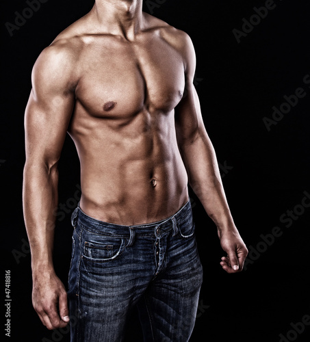 Portrait of handsome man posing on black background