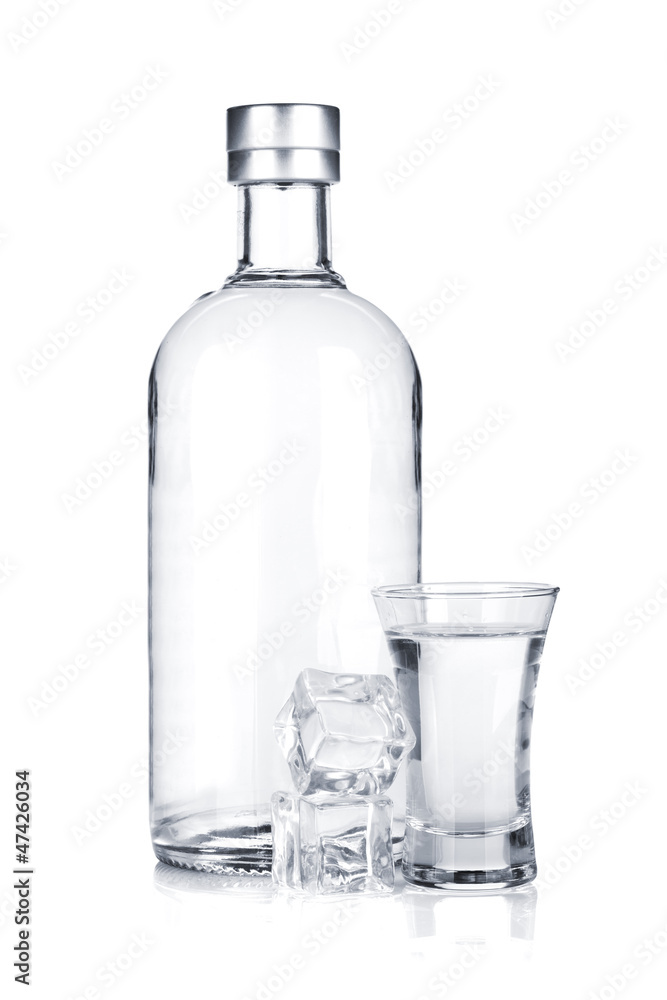 Bottle of vodka and shot glass with ice Bottle of vodka and shot glass with ice