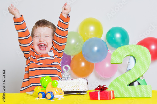 Adorable little boy celebrating second birthday photo