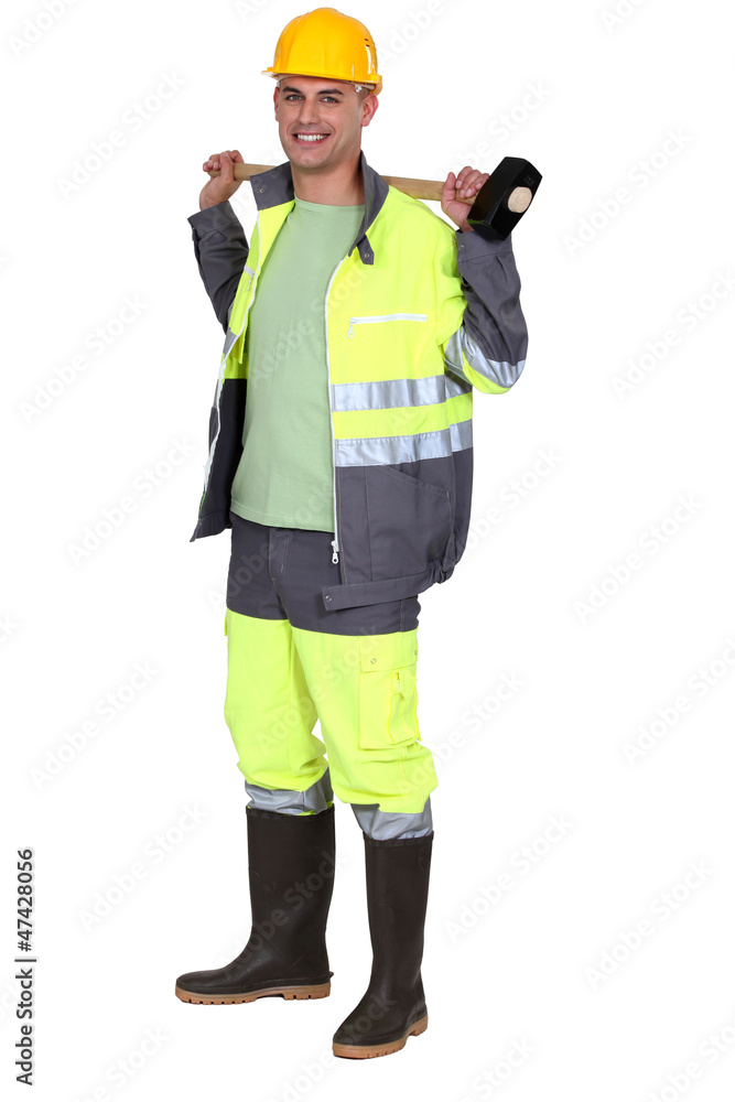 Man holding sledge hammer over shoulder Man holding sledge hammer over shoulder