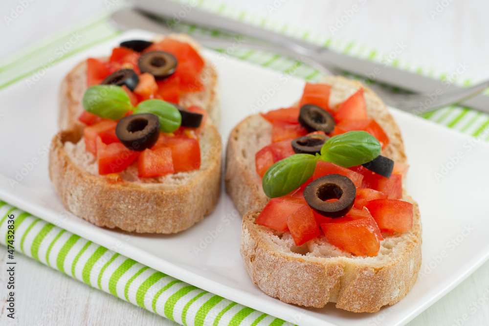 bread with tomato, olives and basil