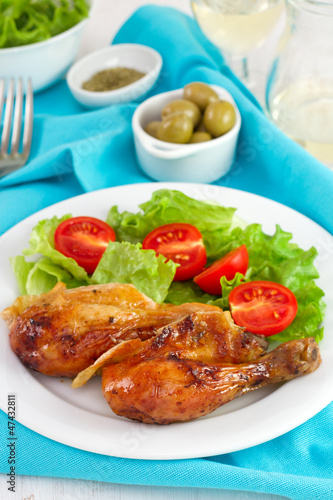 chicken with salad on the plate with glass of wine