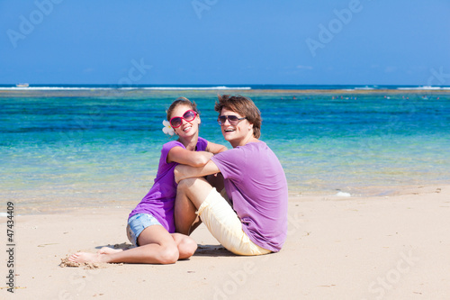 young beautiful couple on tropical bali beach.honeymoon