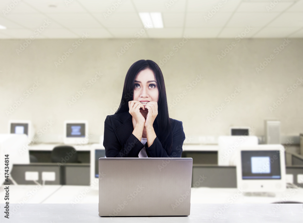 Afraid businesswoman with laptop at office Afraid businesswoman with laptop at office