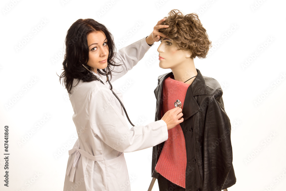 Doctor checking the heartbeat of a dummy Doctor checking the heartbeat of a dummy