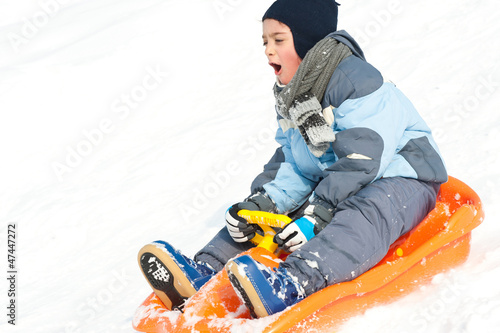 Obraz na plátně Kid sliding with bob in the snow.