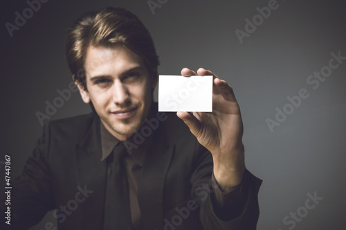 Young man presenting a businesss card photo