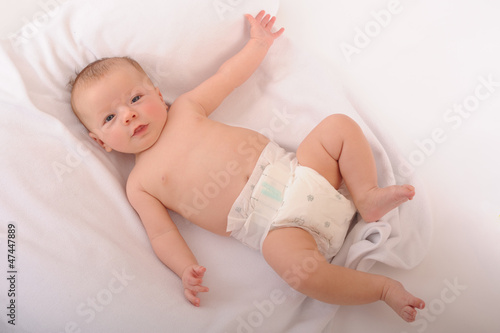 Babby laying down on back