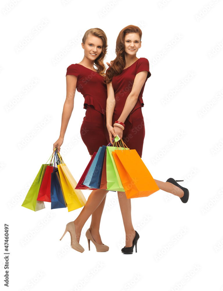 teenage girls in red dresses with shopping bags teenage girls in red dresses with shopping bags