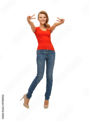 teenage girl in red t-shirt showing victory sign