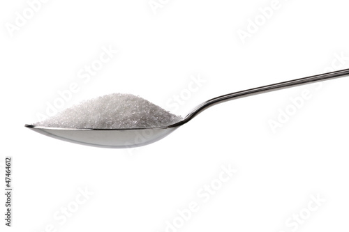 Sugar or salt on a teaspoon photo