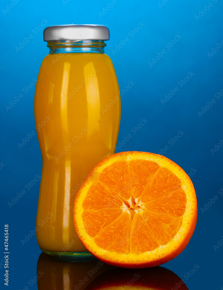 Delicious orange juice in a bottle and orange next to it Delicious orange juice in a bottle and orange next to it