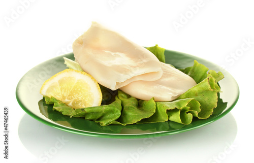boiled squids with lettuce and lemon in the plate isolated