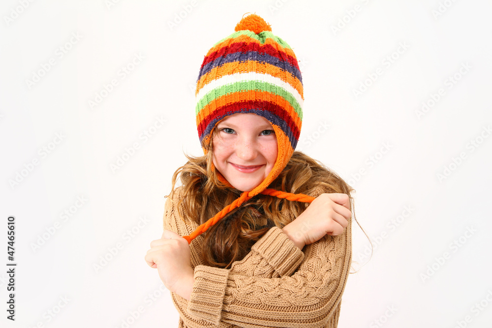 Cheerful little girl in colorful sweater and hat isolated on whi Cheerful little girl in colorful sweater and hat isolated on whi