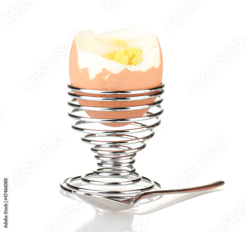 boiled egg in egg cup isolated on white