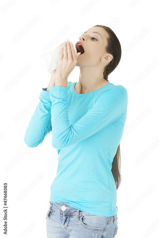 Young woman with tissue - sneezing Young woman with tissue - sneezing