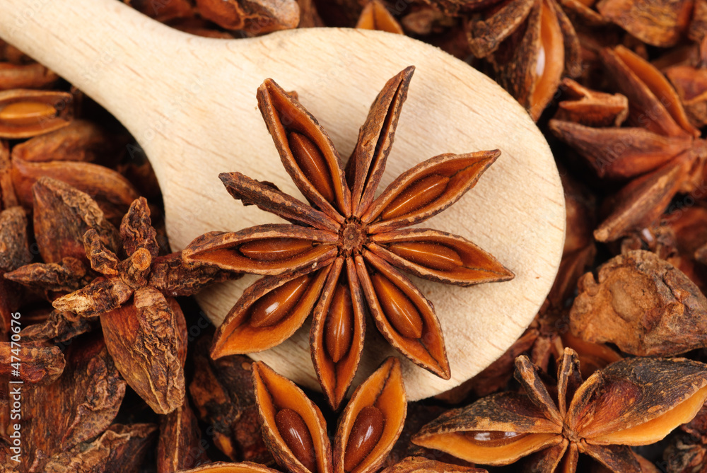 Fresh anise-star with wooden spoon, nature spice background Fresh anise-star with wooden spoon, nature spice background
