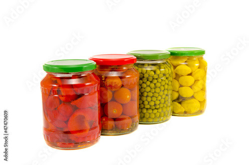 four potted vegetables glas jars isolated on white