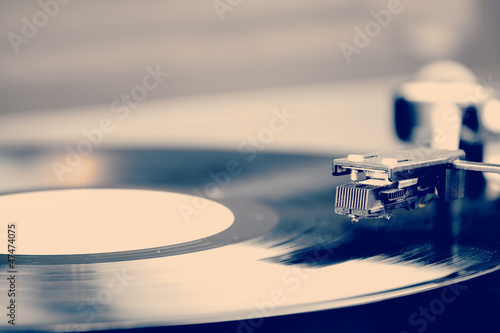 Spinning vinyl record. Motion blur image.  Vintage toned.