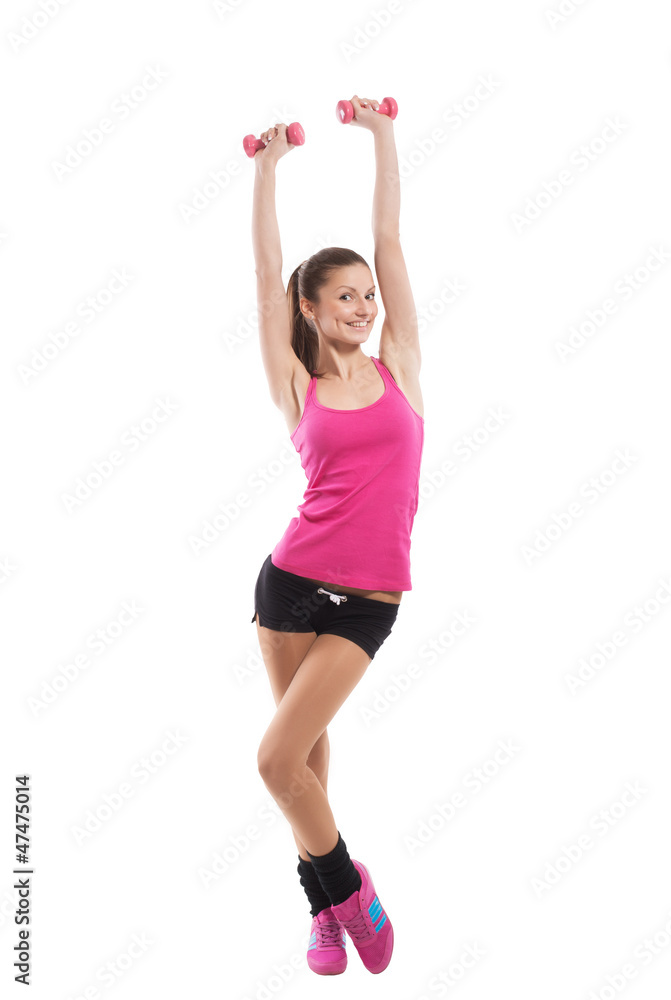 Fit girl raising dumbbells up and smiling, white background Fit girl raising dumbbells up and smiling, white background