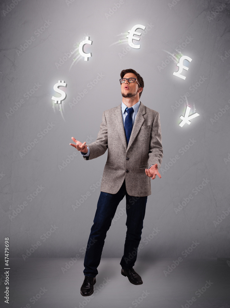 young man standing and juggling with currency icons young man standing and juggling with currency icons