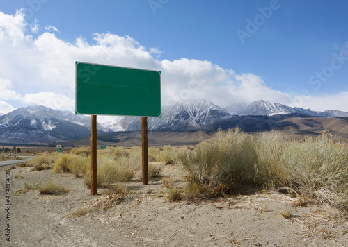Blank green road sign board in rural area