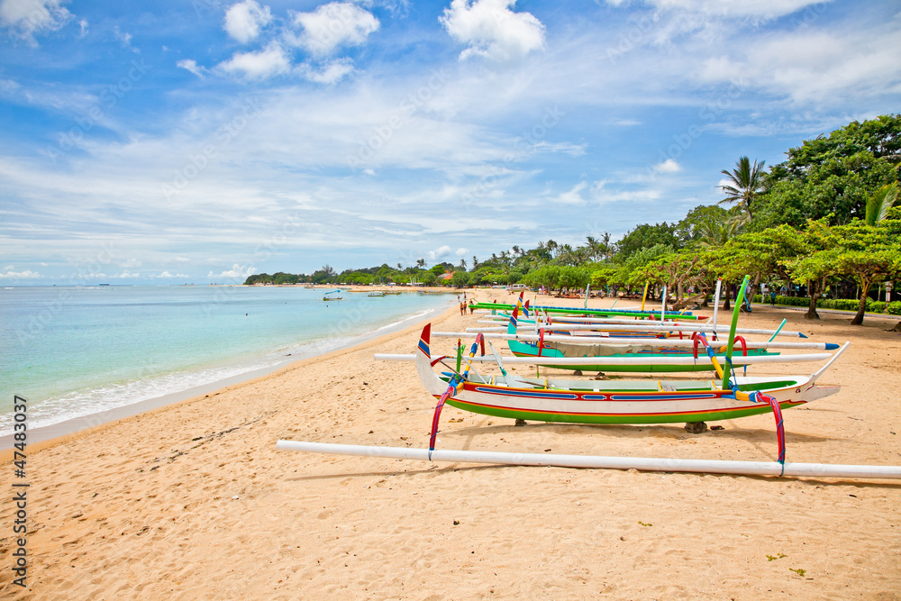 Beautiful tropical beach with fisherman's boats in Nusa Dua on B
