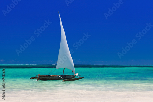 wooden boat in crisp blue water