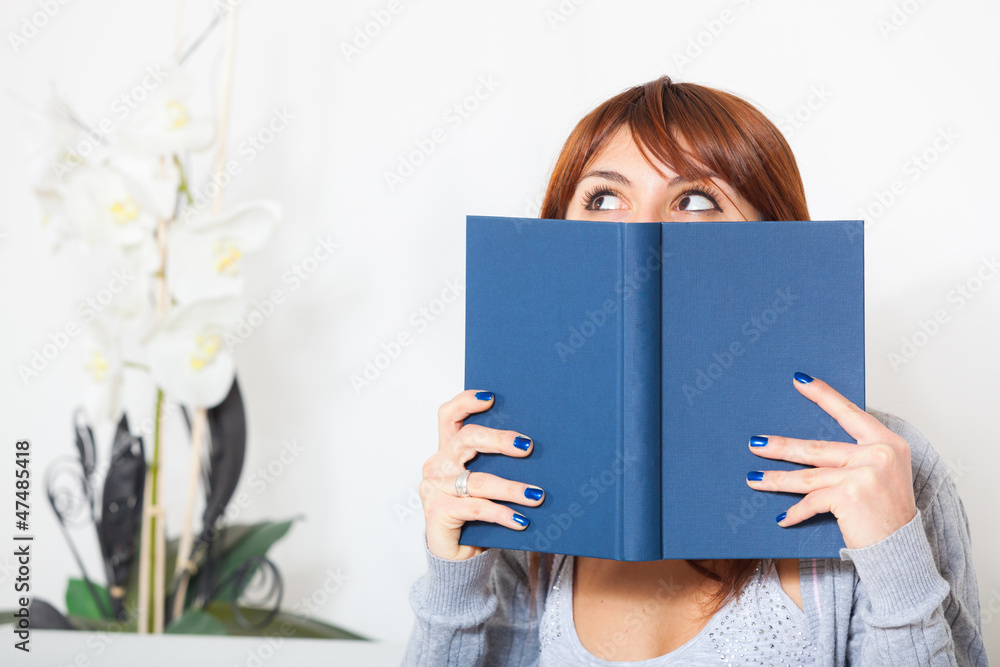 Beautiful Young Woman with a Book on the Sofa Beautiful Young Woman with a Book on the Sofa