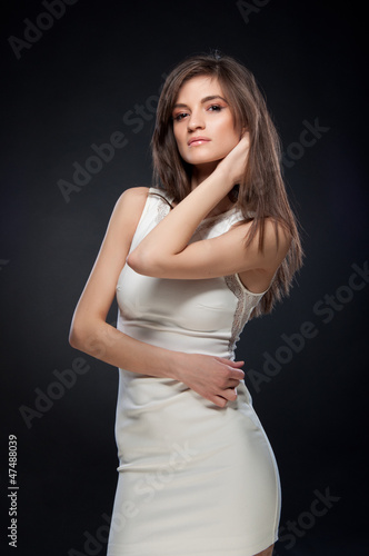 brunette woman wearing a white dress