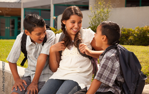 Hispanic Brothers and Sister Talking Ready for School