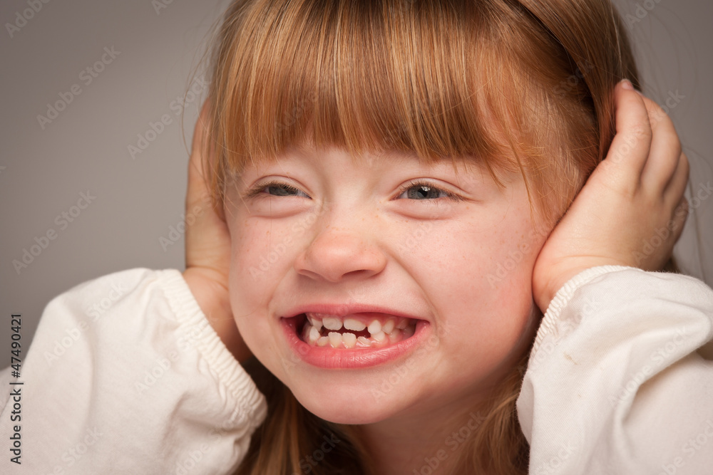 Fun Portrait of an Adorable Red Haired Girl on Grey Fun Portrait of an Adorable Red Haired Girl on Grey