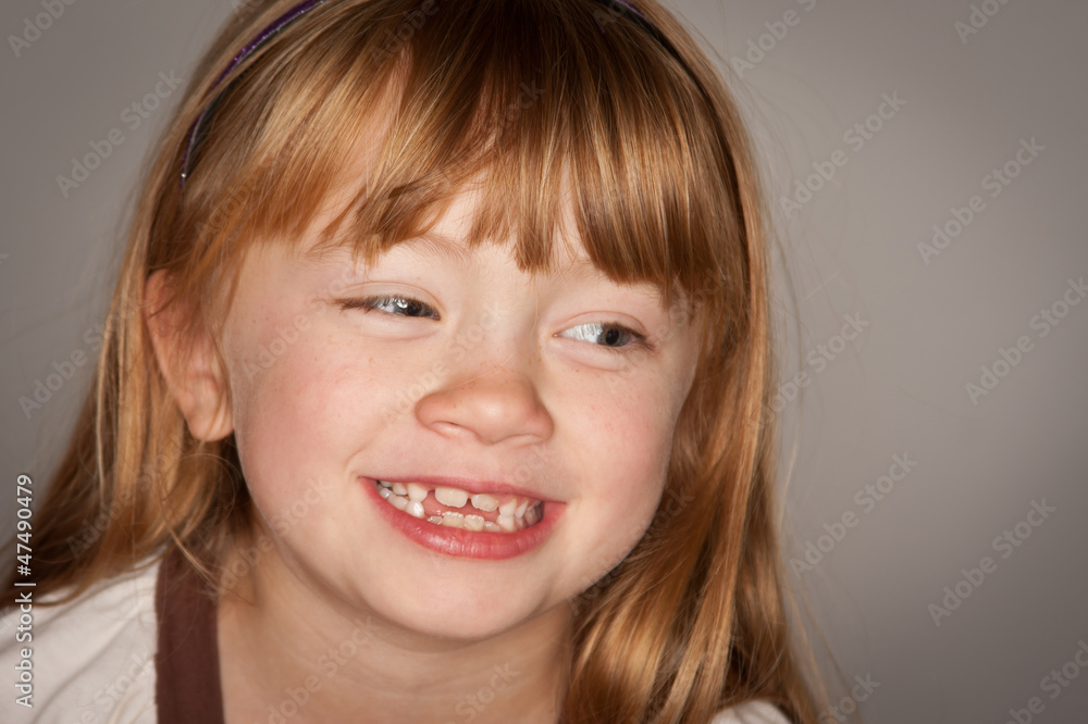 Fun Portrait of an Adorable Red Haired Girl on Grey Fun Portrait of an Adorable Red Haired Girl on Grey