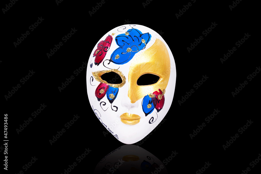 Venetian mask on a black background with reflection