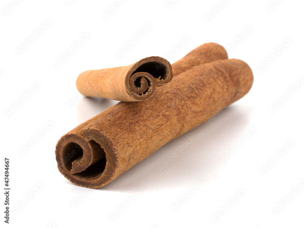 Two cinnamon sticks stacked on white background Two cinnamon sticks stacked on white background