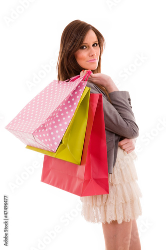 happy smiling young woman holding shopping bags isolated on whit