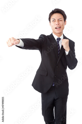 Young businessman hitting a straight punch