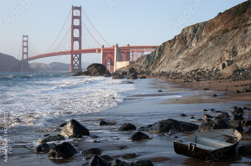 Golden Gate Bridge and a boat at beach - San Francisco
