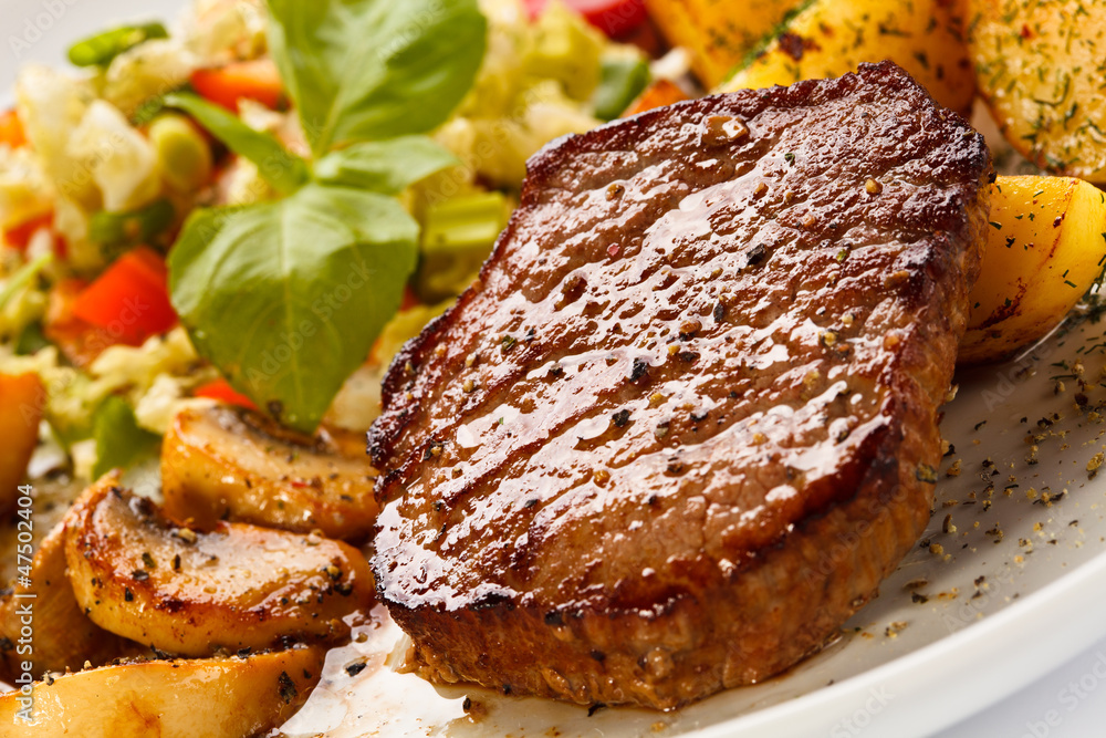 Grilled steak, baked potatoes and vegetables Grilled steak, baked potatoes and vegetables