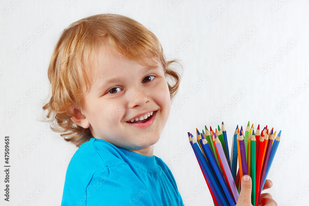 Smiling child with color pencils on a white background Smiling child with color pencils on a white background
