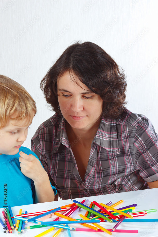 Little cute boy with his mother draws with color pencils Little cute boy with his mother draws with color pencils