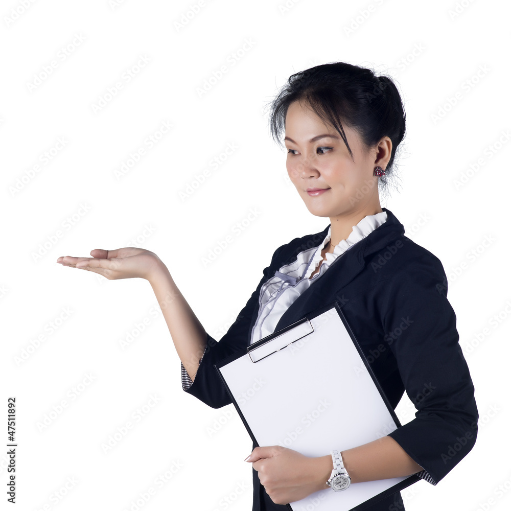 Happy smiling young business woman showing blank area for sign o Happy smiling young business woman showing blank area for sign o