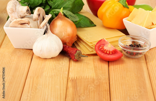 Vegetarian lasagna ingredients on wooden background