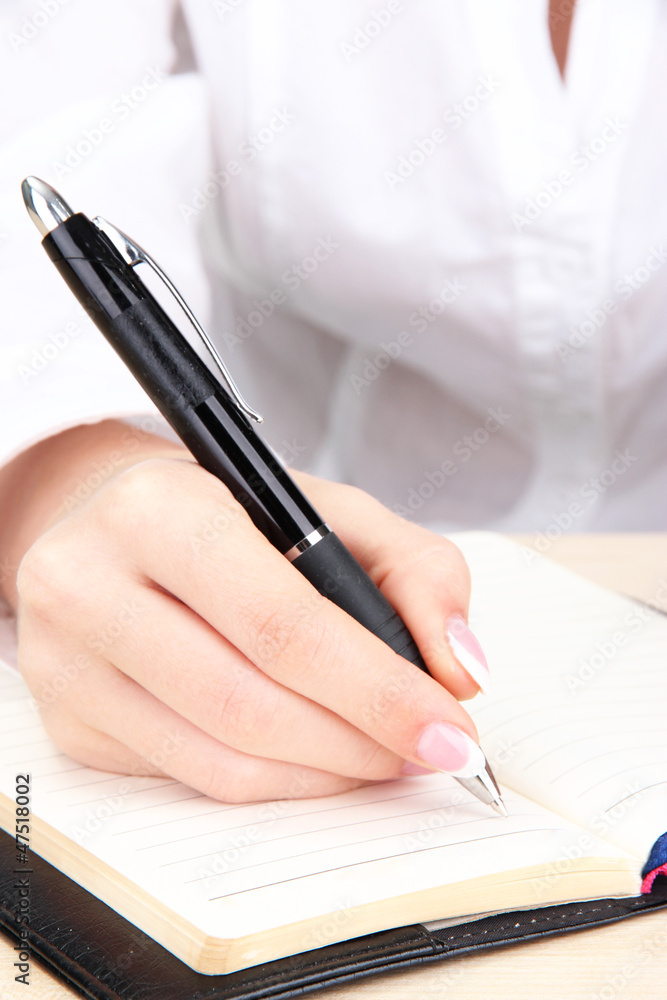 Closeup of businesswoman hand, writing on paper Closeup of businesswoman hand, writing on paper