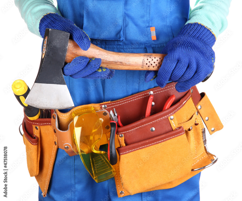 Male builder in blue overalls with hatchet isolated on white Male builder in blue overalls with hatchet isolated on white
