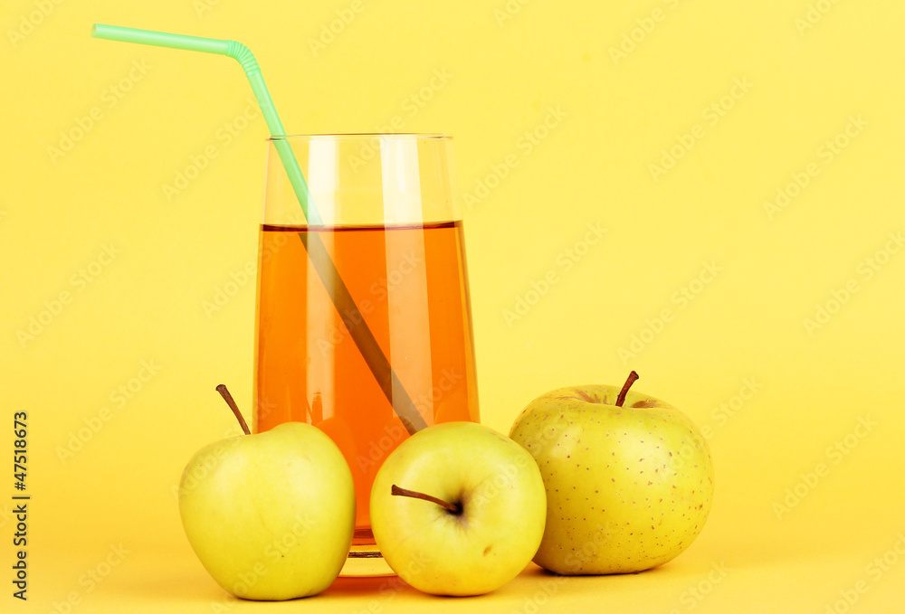 Useful apple juice with apples around on yellow background Useful apple juice with apples around on yellow background